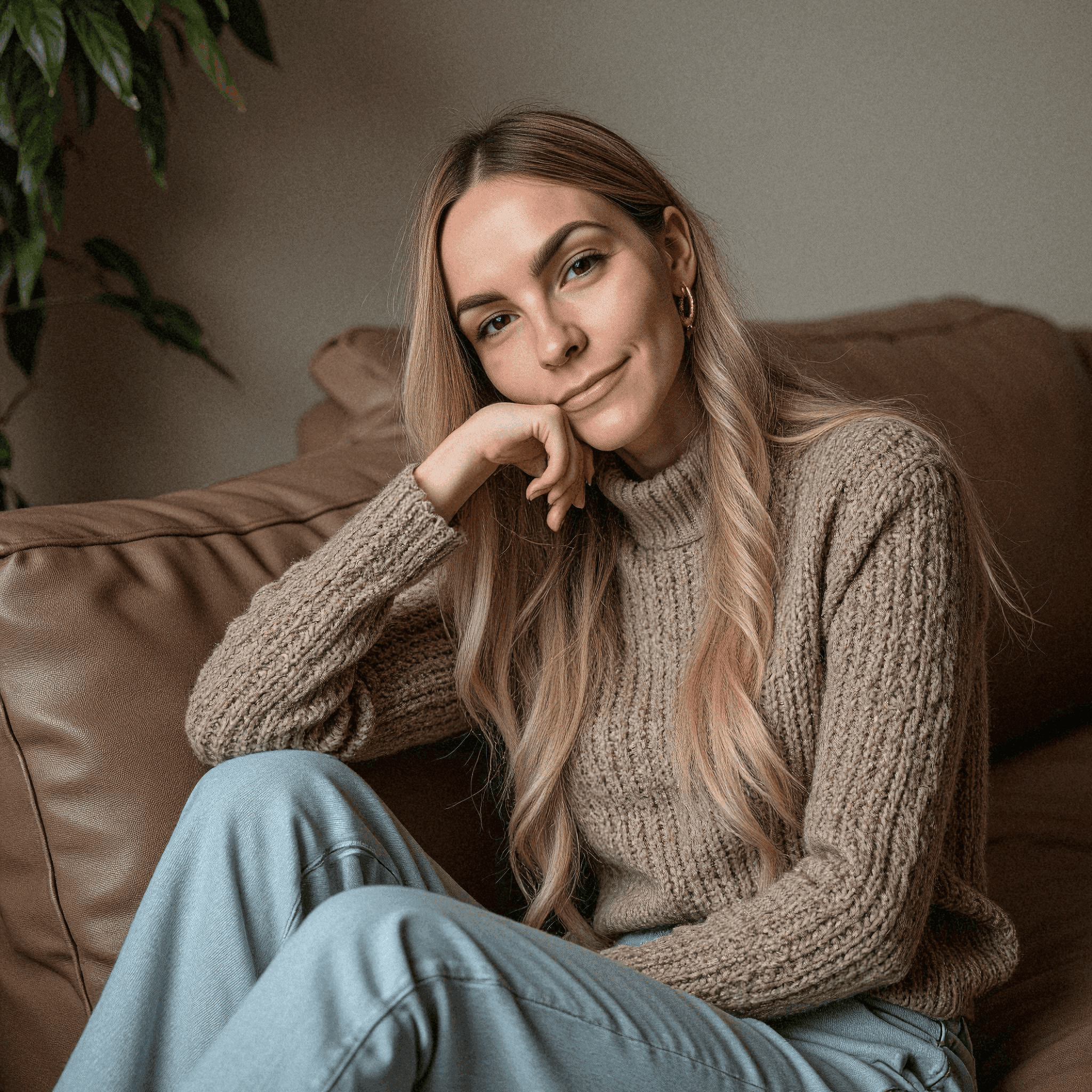 Woman in Cozy Sweater on Brown Sofa