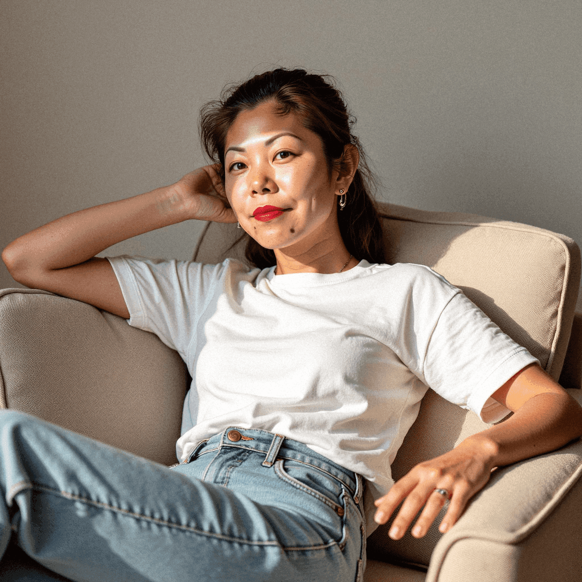 Woman lounging in white tee and jeans