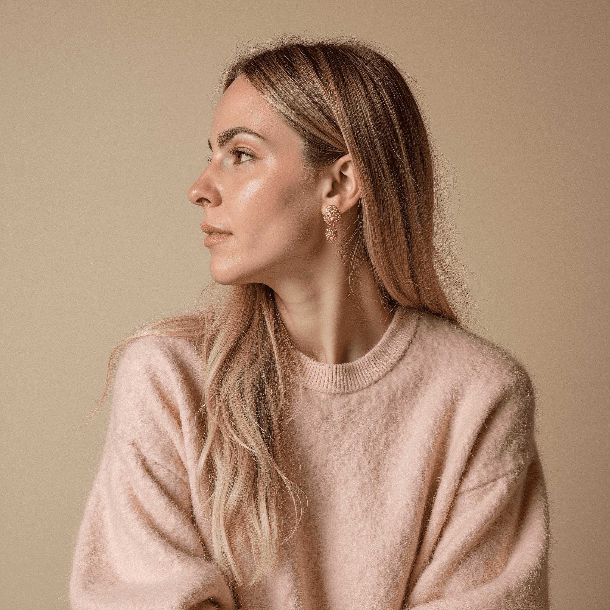 Woman in Pink Sweater with Golden Earrings