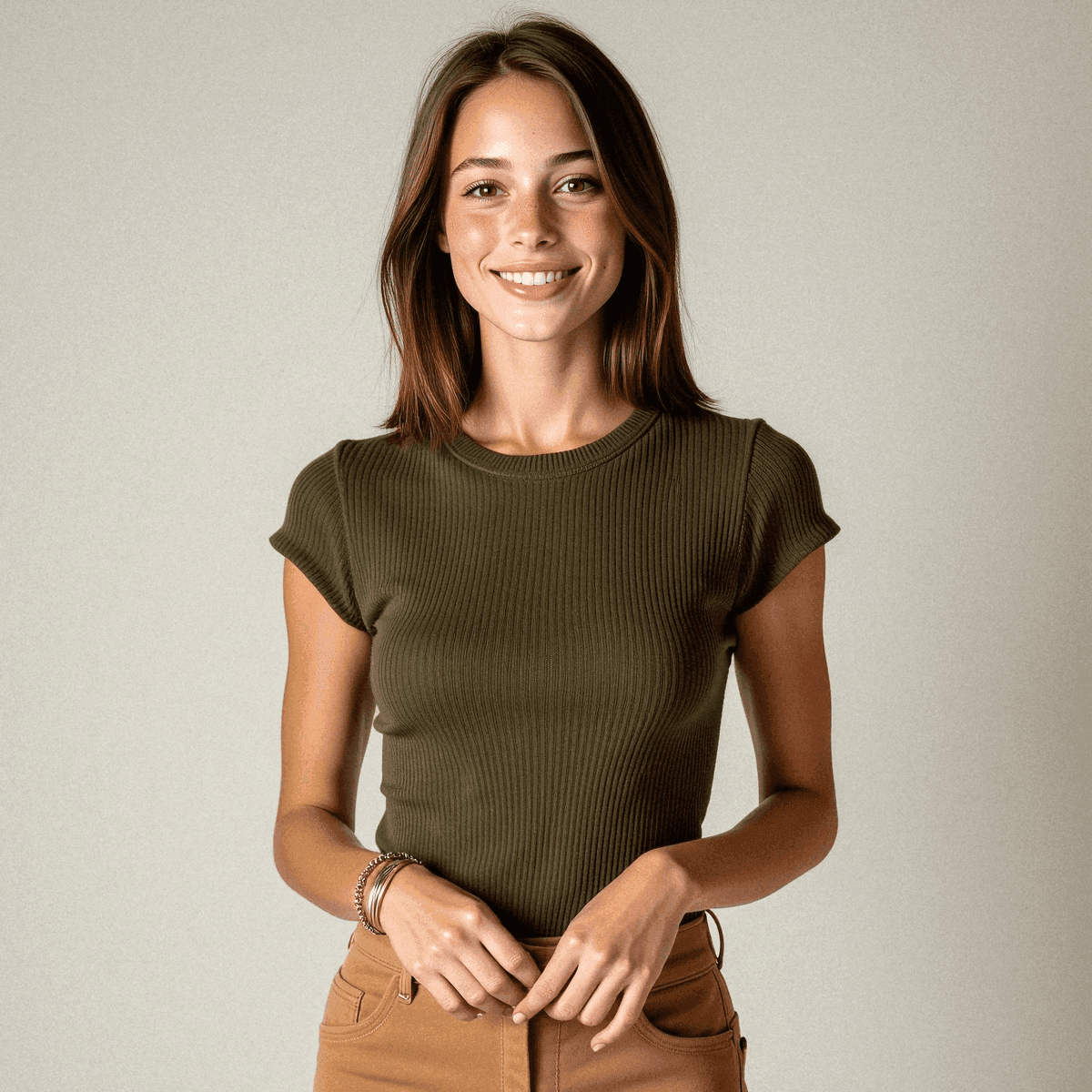 Woman in olive top and tan slacks