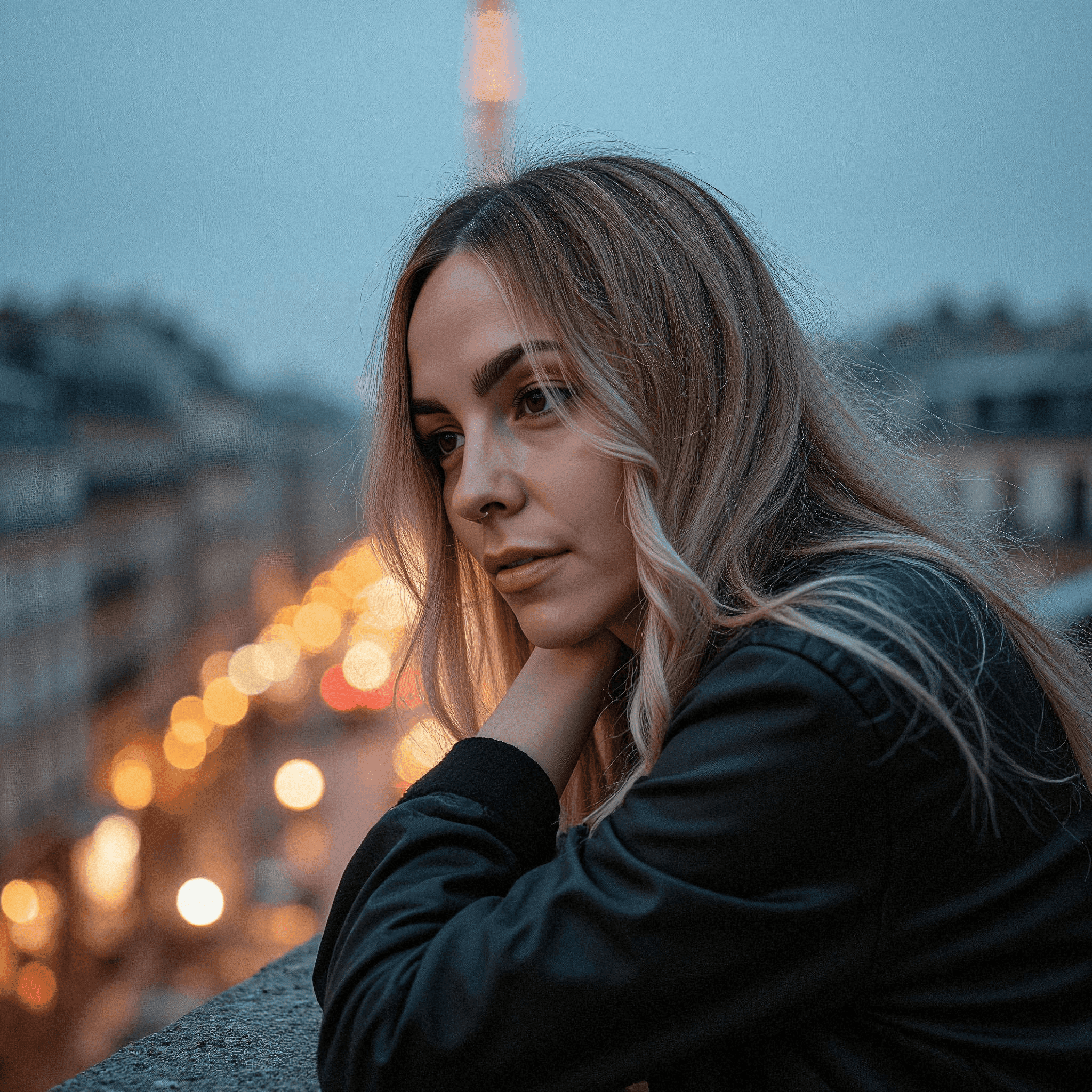 Woman gazing over Paris at dusk